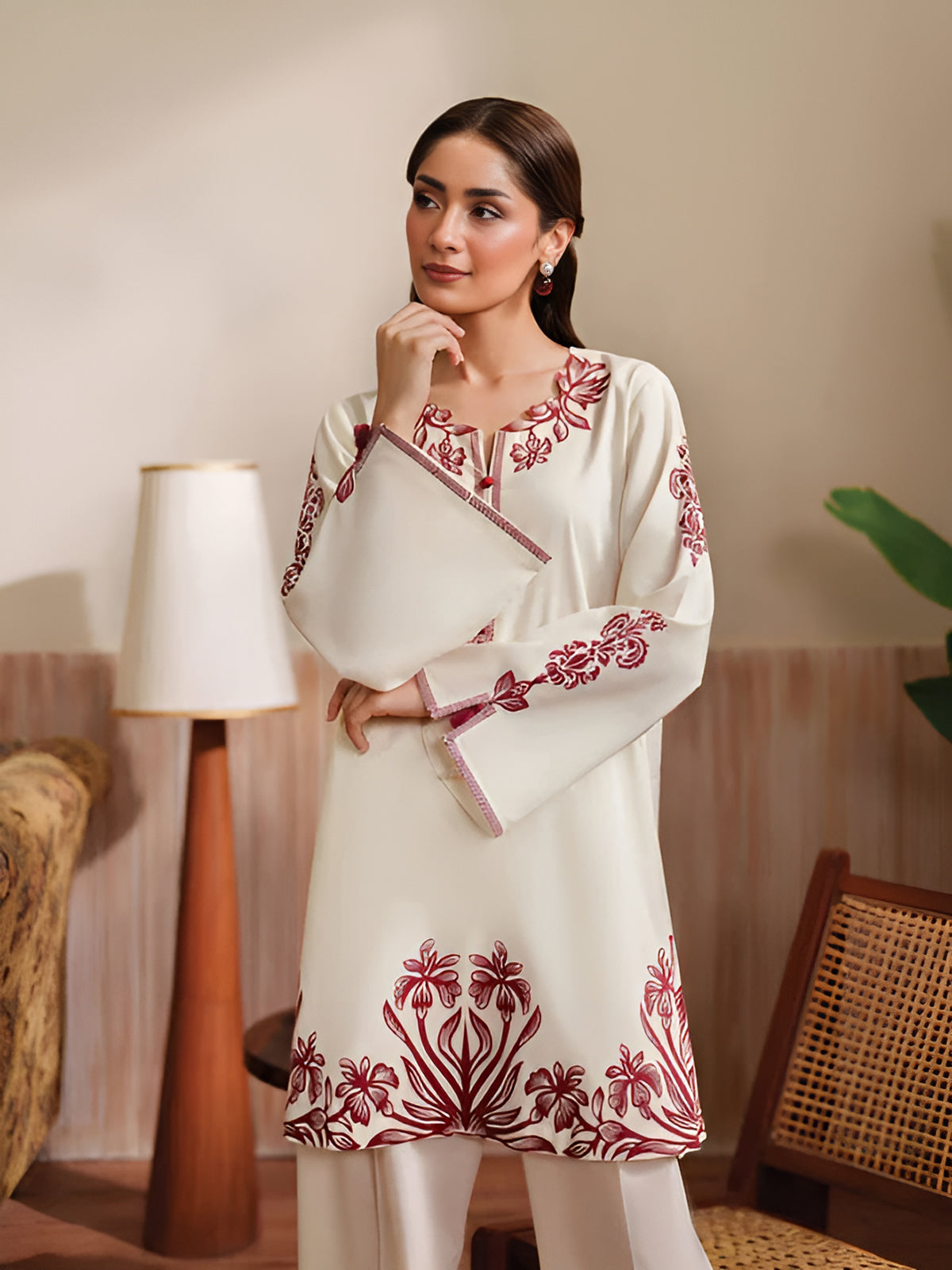 Cloothy Embroidered Collection featuring a model wearing a black and gold embroidered 2-piece lawn suit with intricate patterns.