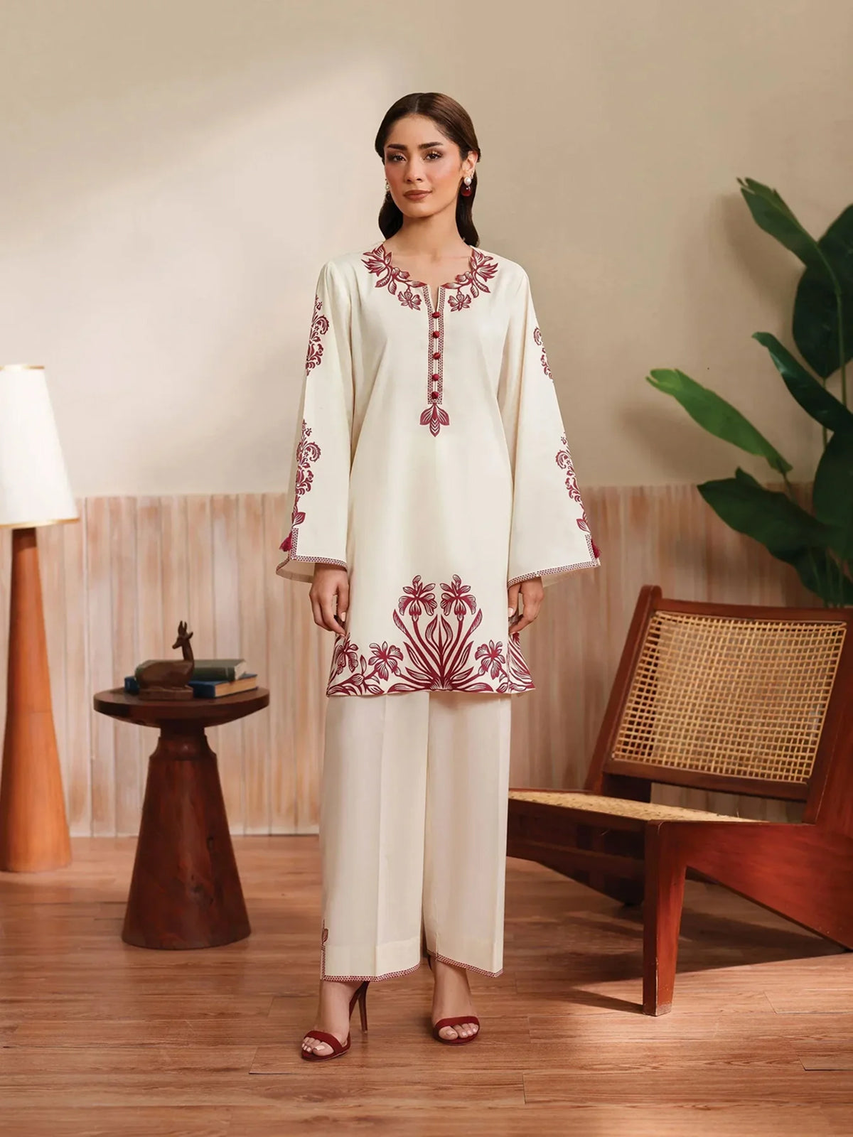 Cloothy Embroidered Collection featuring a model wearing a black and gold embroidered 2-piece lawn suit with intricate patterns.