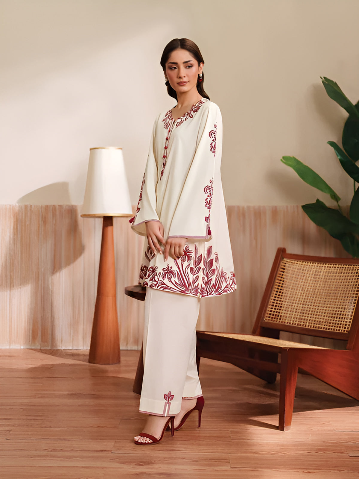 Cloothy Embroidered Collection featuring a model wearing a black and gold embroidered 2-piece lawn suit with intricate patterns.