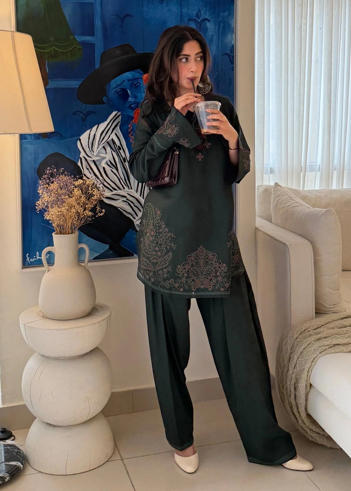 Model wearing Cloothy Bahaar Edit black lawn suit featuring elegant embroidery and short shirt design.