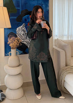 Model wearing Cloothy Bahaar Edit black lawn suit featuring elegant embroidery and short shirt design.