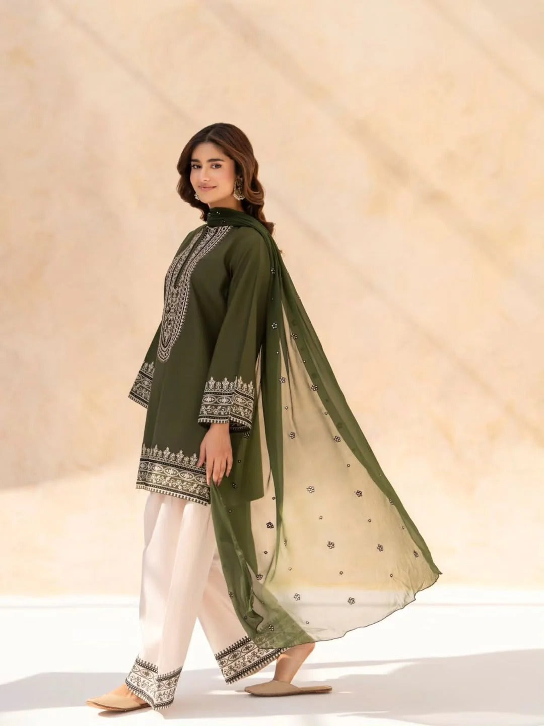 Roshni 2-piece embroidered lawn suit in deep green with intricate neckline detailing by Cloothy.